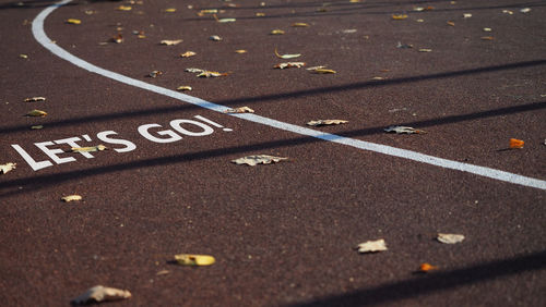 Sign let's go. empty sports field, running track marking. abstract treadmill, color. pursuit goal