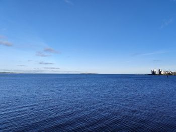Scenic view of sea against blue sky