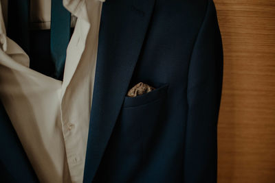 Close-up of suit hanging at wall