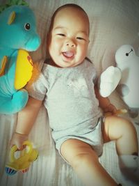 Portrait of baby girl playing with toy