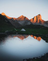 Scenic view of lake by mountain against sky