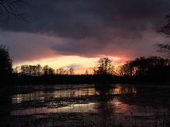 Scenic view of lake against sky at sunset