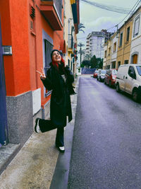 Portrait of young woman walking on street