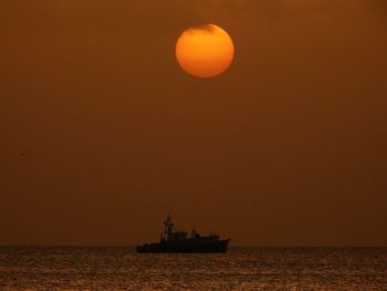 Scenic view of sea against orange sky