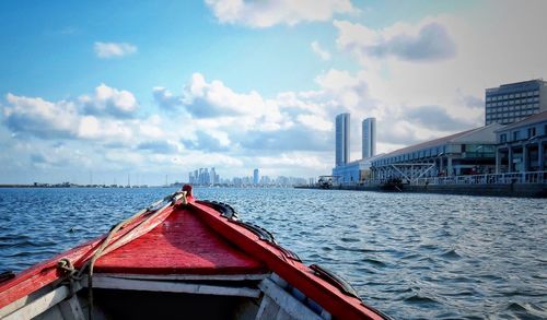 Panoramic view of city by sea against sky