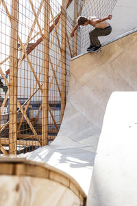 Low angle view of shirtless man skateboarding