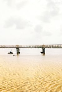 Bridge over sea against sky