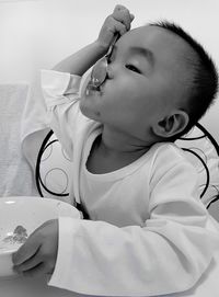 Close-up of baby boy eating food at home