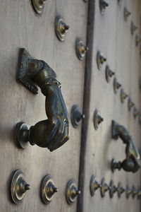 Close-up photo of a wooden door with metal door knockers