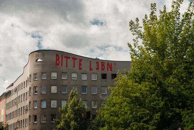 Low angle view of building against cloudy sky