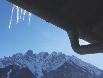 Low angle view of mountains against clear blue sky