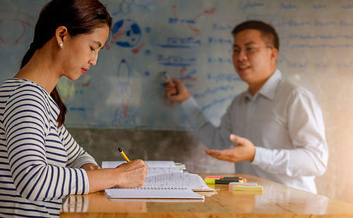 Colleagues working at desk in office