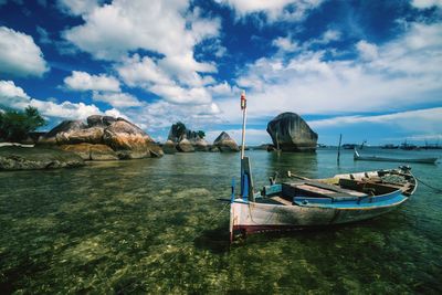 Boats moored on sea against sky