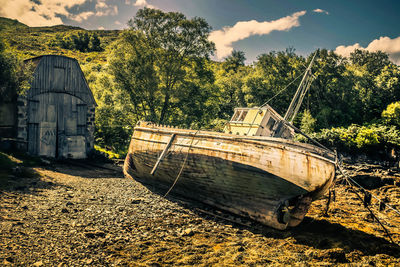 Abandoned boat against sky