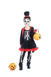 Full length of boy standing against white background