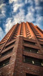 Low angle view of building against cloudy sky