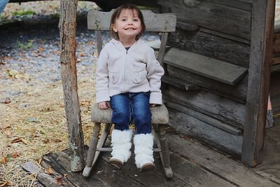 Portrait of smiling woman standing on wood