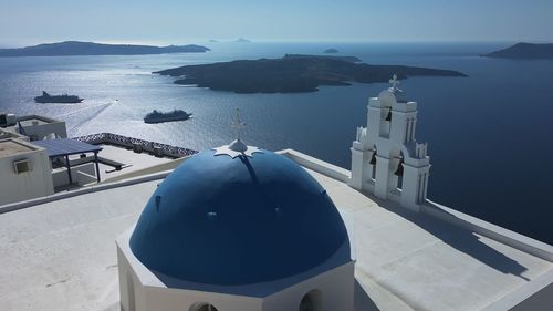 Three bells of fira, catholic church of the dormition, with the caldera in the background. santorini