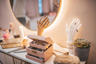 Cropped hand of woman holding food on table