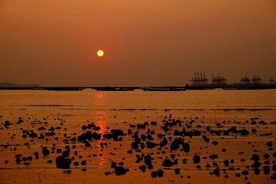 Scenic view of beach against sky during sunset