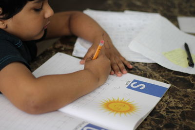 Boy studying on the floor