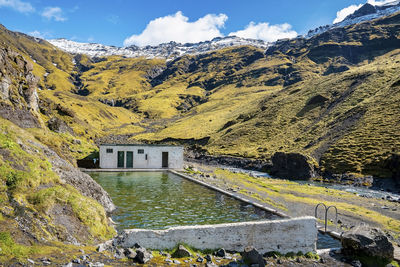 Beautiful seljavallalaug natural geothermal hotspring pool against mountains