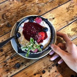 High angle view of woman holding bowl of food