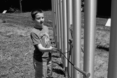 Boy playing musical instrument on field