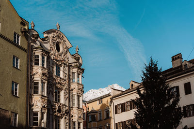 Low angle view of buildings against clear blue sky