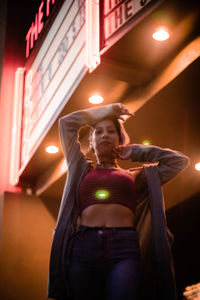 Midsection of man standing in illuminated room