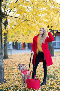 Portrait of woman with dog during autumn