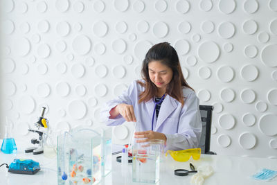 Scientist performing scientific experiment at laboratory