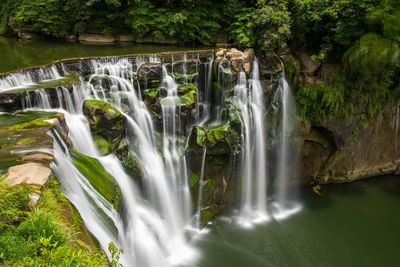 Scenic view of waterfall in forest