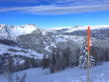 Snow covered mountain against blue sky