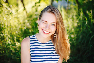 Close-up portrait of smiling young woman