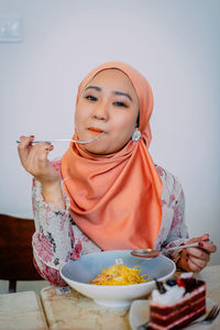 Midsection of woman holding ice cream