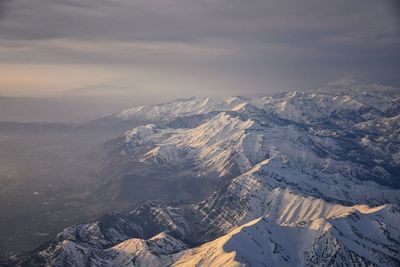 Wasatch front rocky mountain range aerial snow capped peaks winter urban salt lake city utah usa