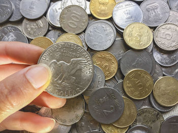 High angle view of hand holding coins