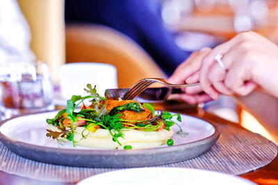 Close-up of hand holding food in restaurant