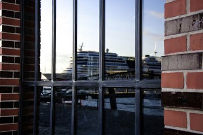 Cruise ship seen through metal gate