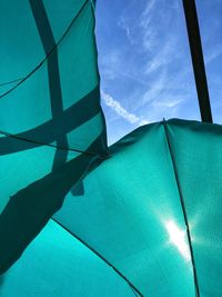 Low angle view of parasols against sky