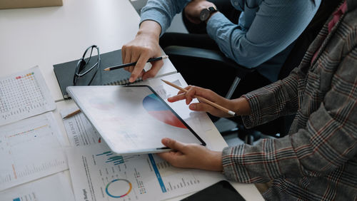 Midsection of business colleagues working at office