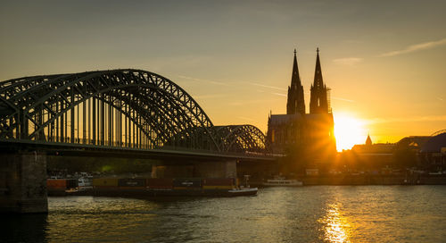 Bridge over river during sunset