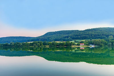 Scenic view of lake and mountains against sky