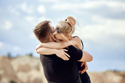 Rear view of couple standing outdoors