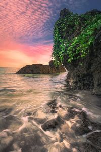 Scenic view of sea against cloudy sky