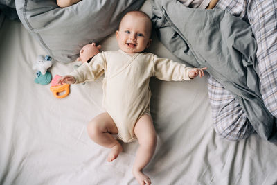 High angle view of cute baby boy sleeping on bed at home