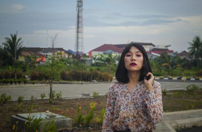 Portrait of young woman standing outdoors