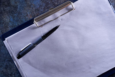 High angle view of pen and book on table