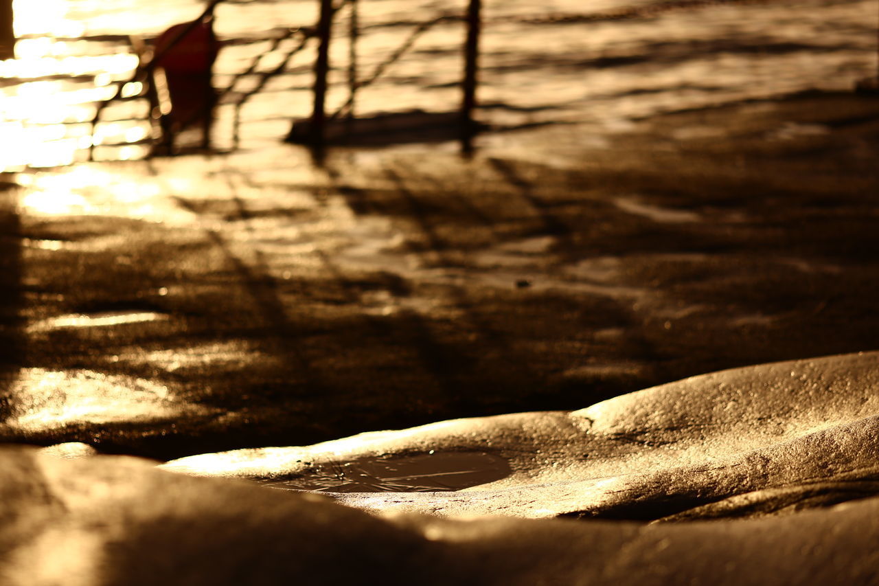 CLOSE-UP OF WOOD ON SAND